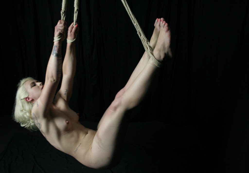 Nude girl in suspension bondage